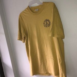 Yellow peace sign t-shirt.